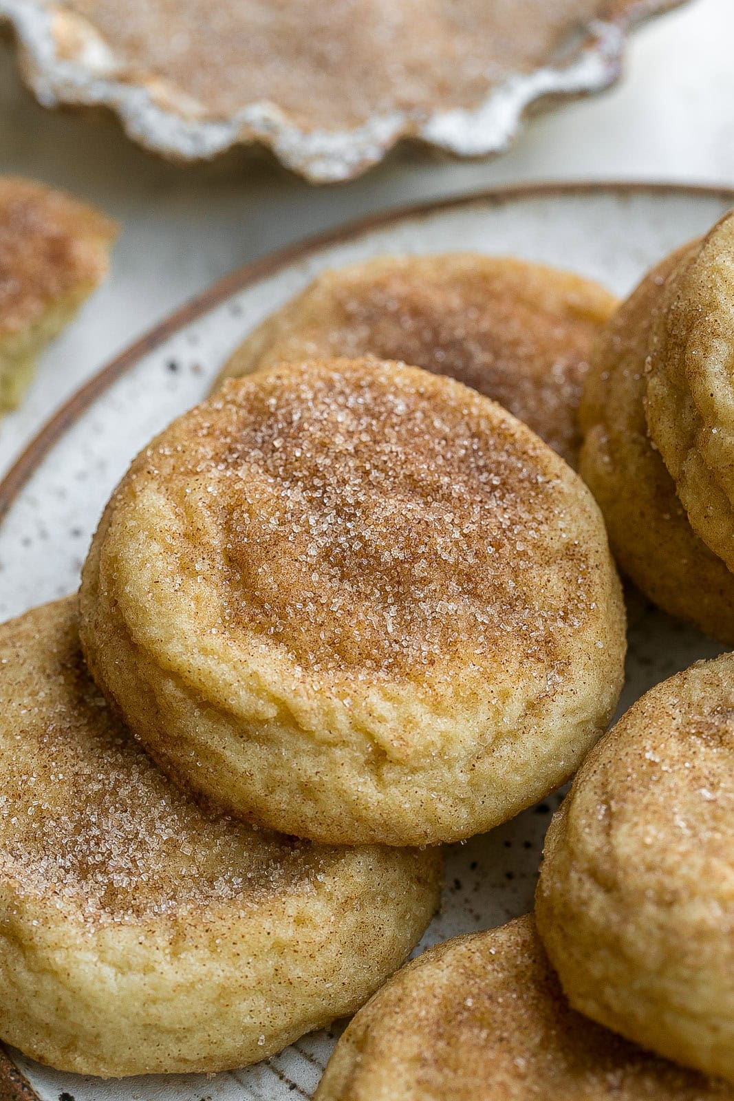 Cinnamon sugar coated snickerdoodle cookie on a plate.