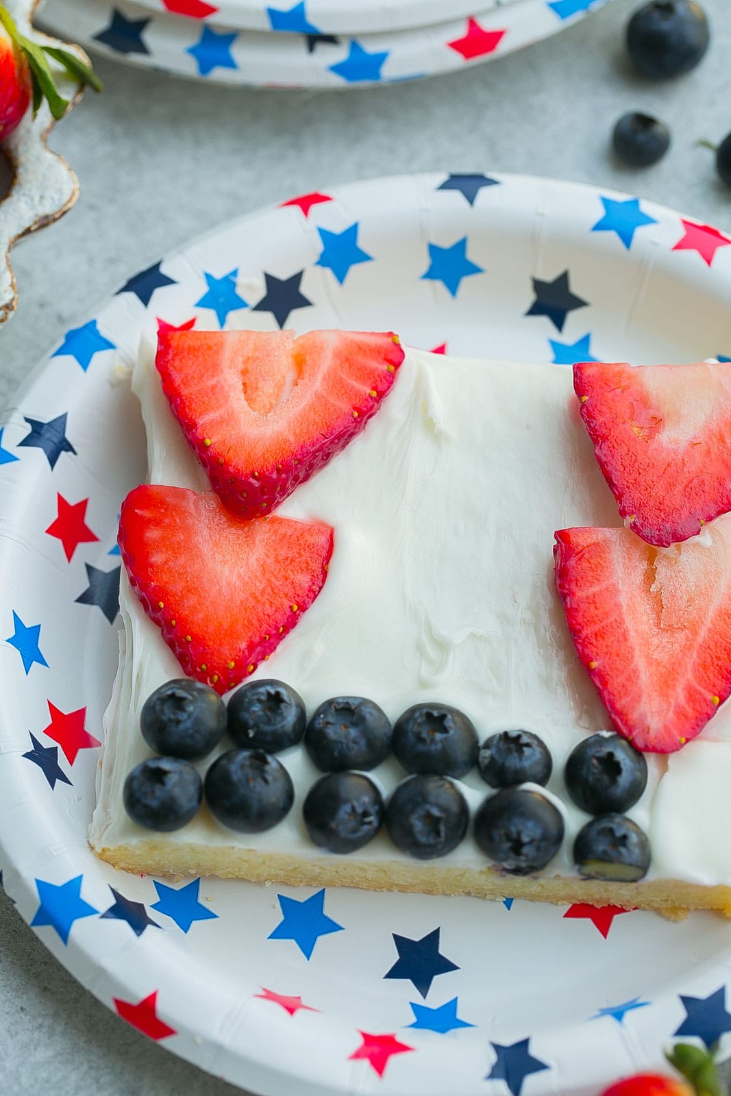 Close up view of a piece of American Flag Fruit Pizza.
