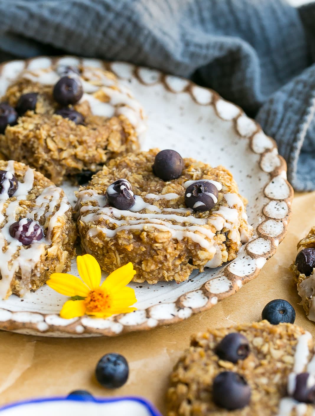 Oatmeal breakfast cookies on a plate with blueberries.