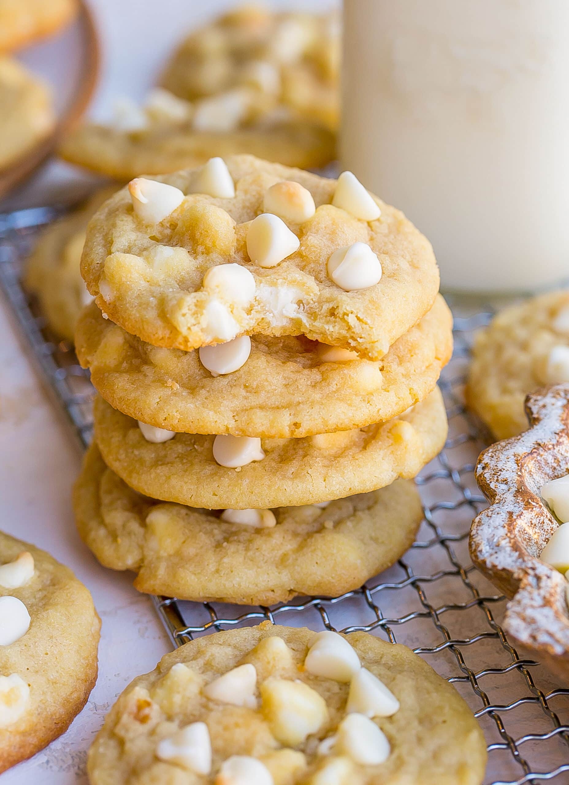 Stack and a bite out of a white chocolate cookie.