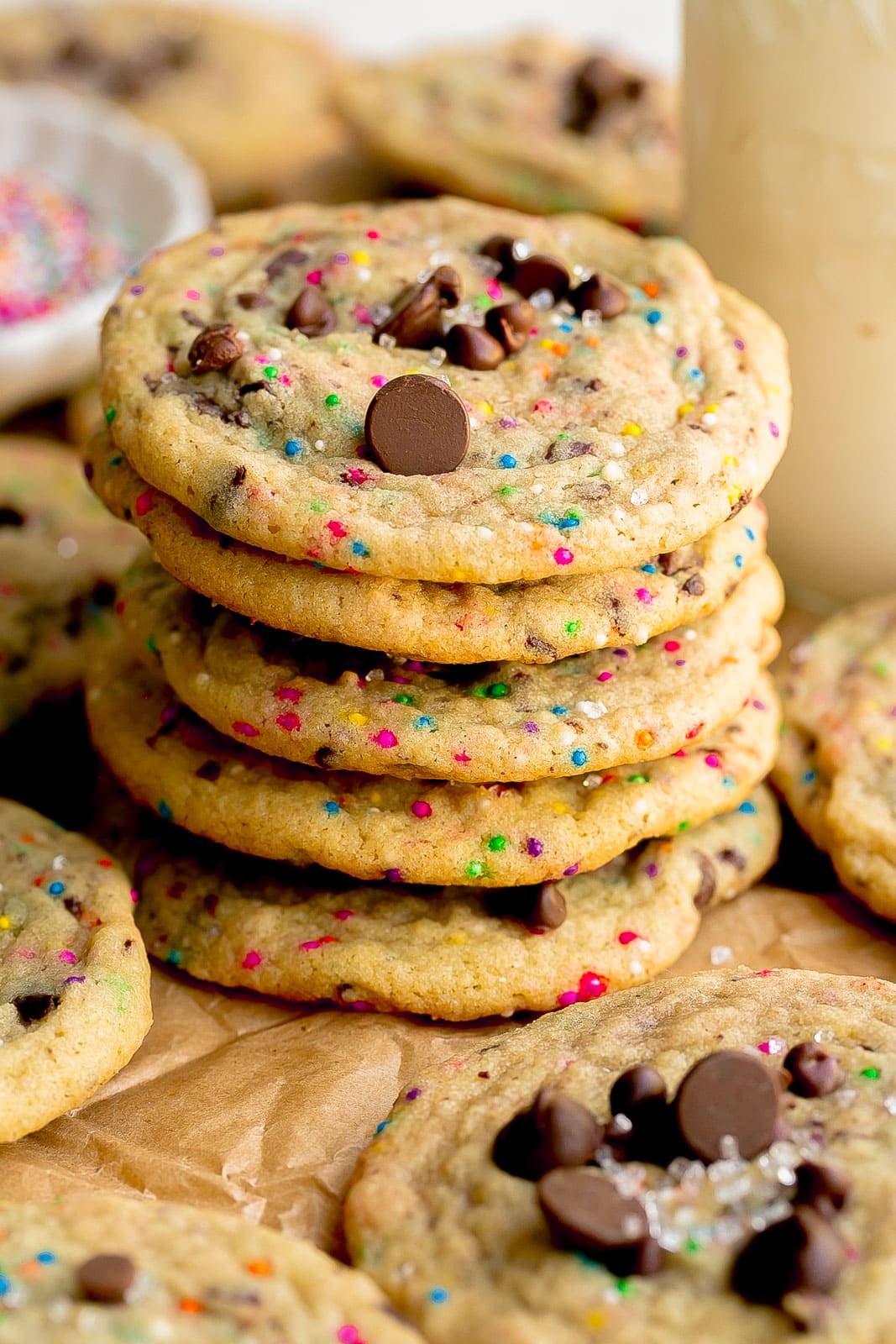 Stack of sugar cookies with chocolate chips and sprinkles.