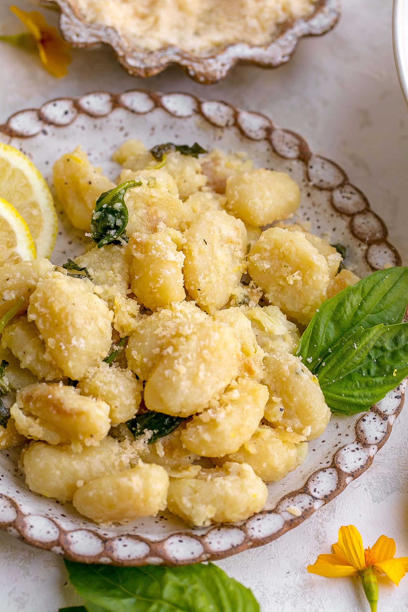 Plate of Garlic Parmesan Gnocchi and fresh basil on top.