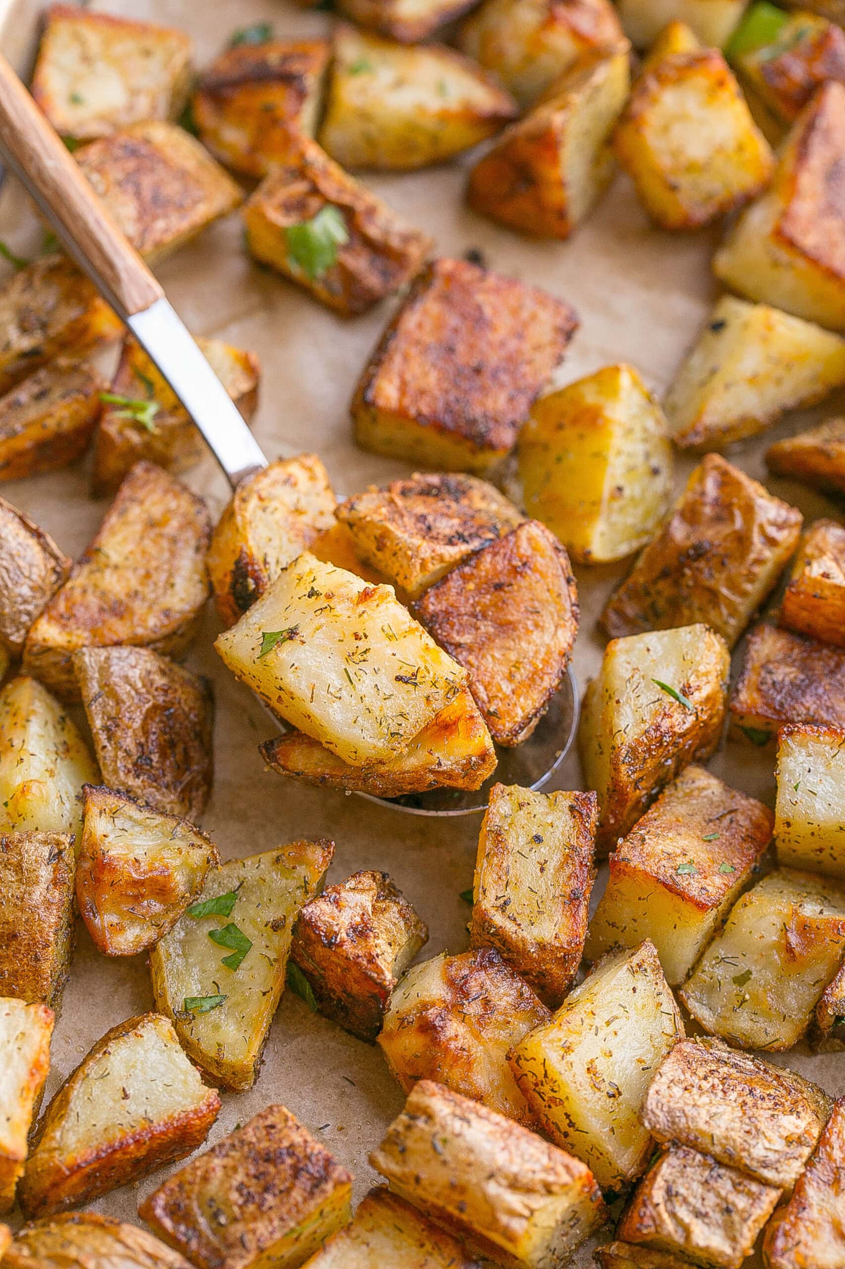 Spoonful of ranch potatoes on baking sheet.