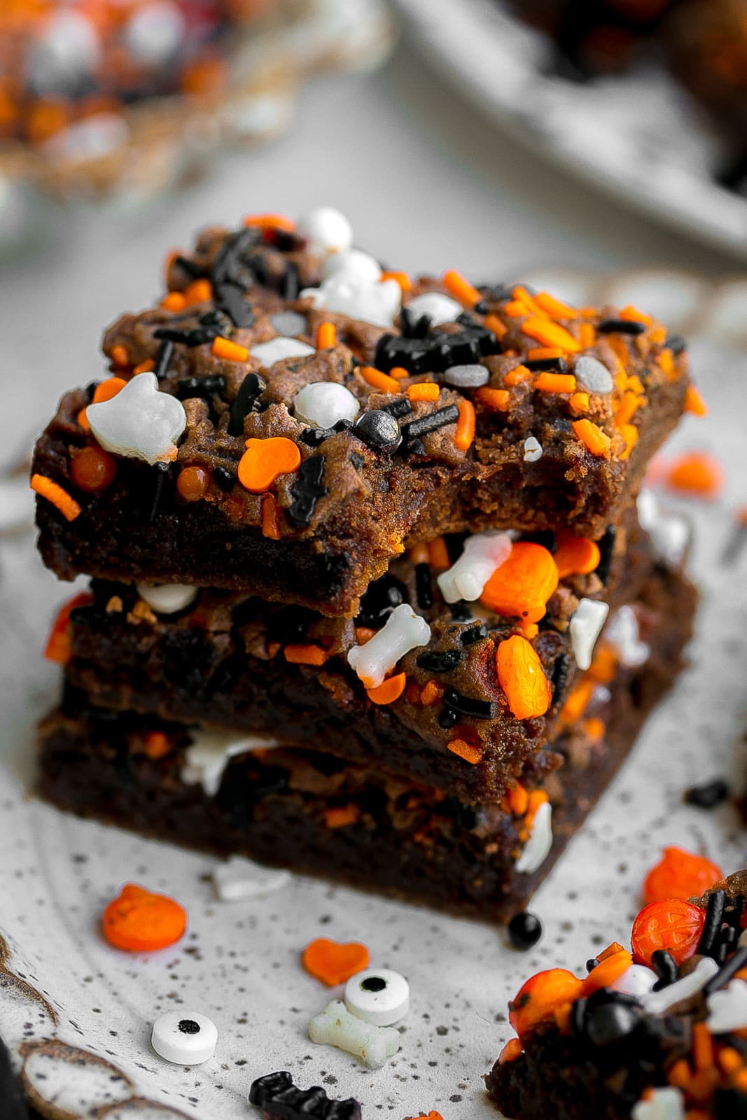 Stack of Halloween Cookie Bars with bite mark.