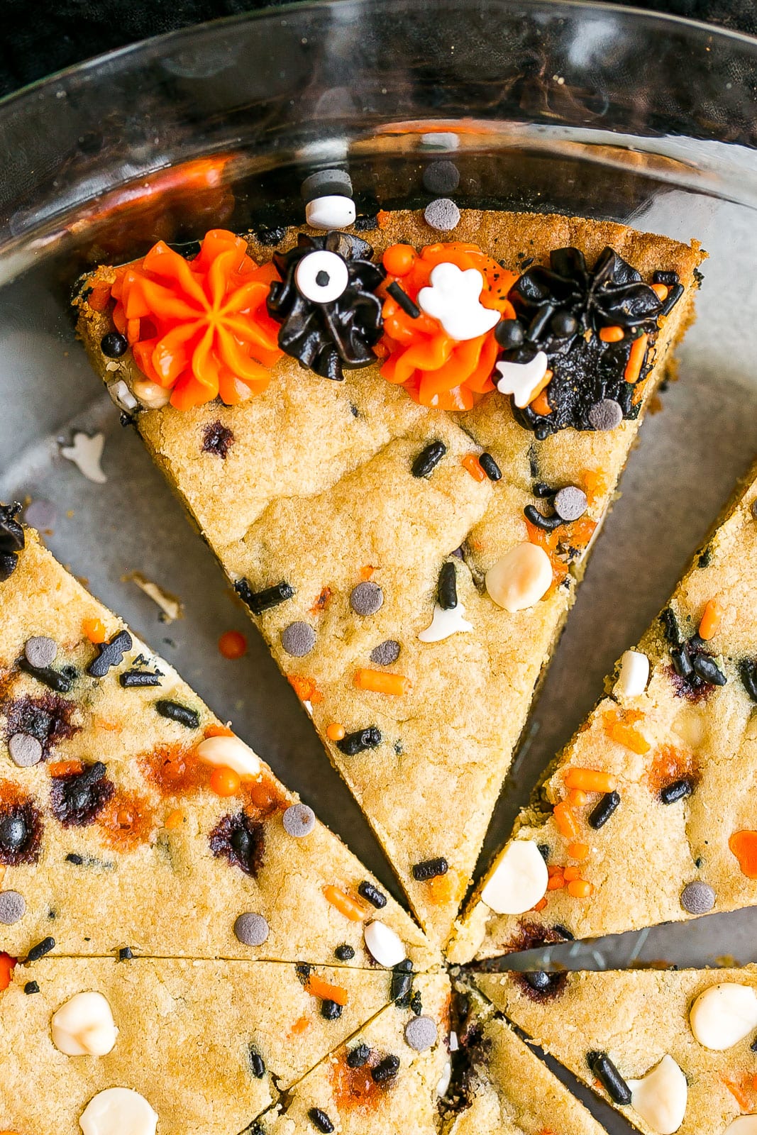 Slice of cookie cake with halloween decorations.