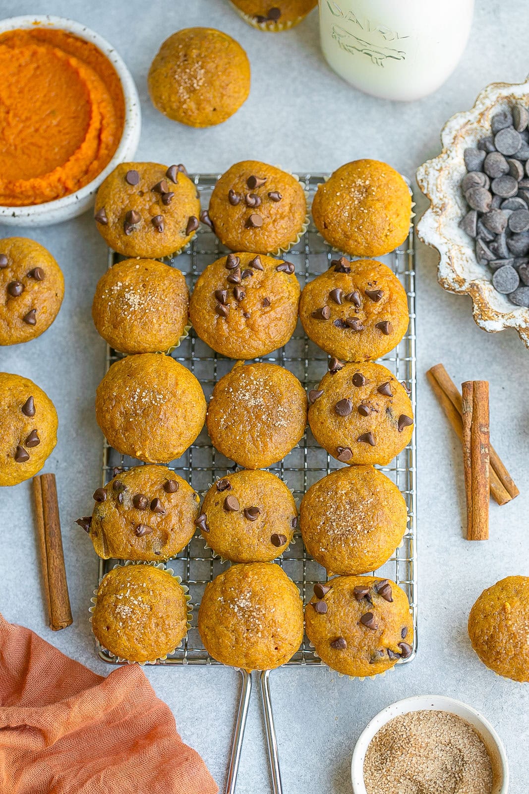 Mini muffins with pumpkin on a cooling rack.