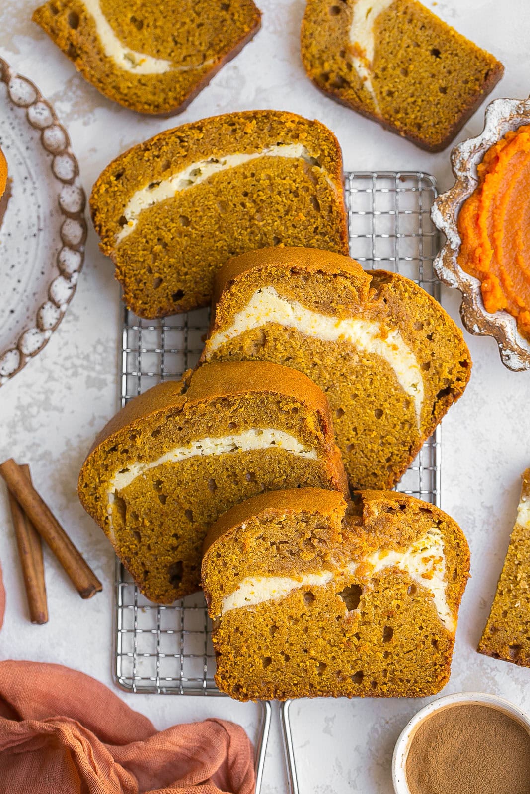 Cooling rack with sliced of Pumpkin Cream Cheese Bread.