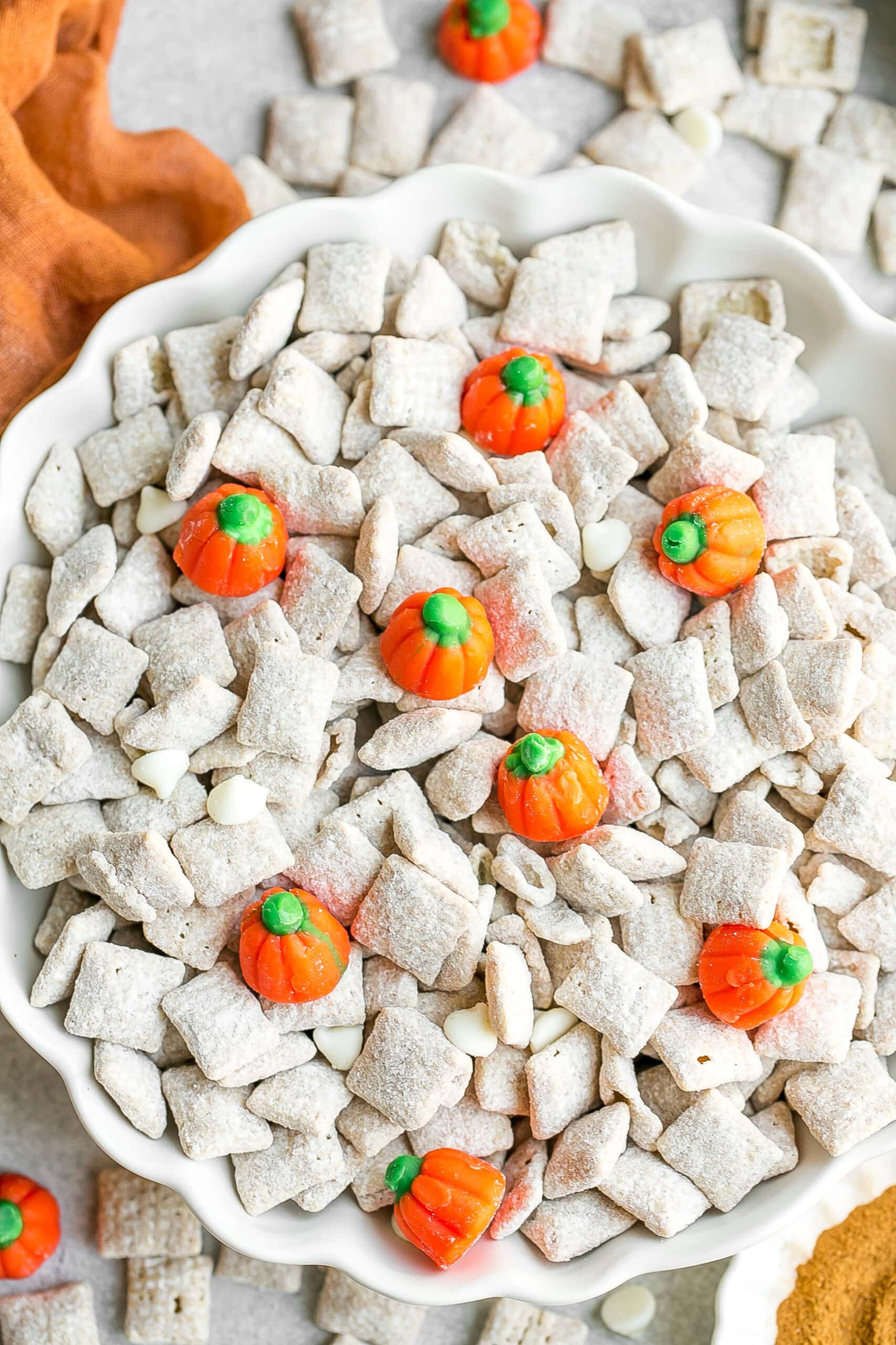 Pumpkin Spice Puppy Chow in a white bowl dish.