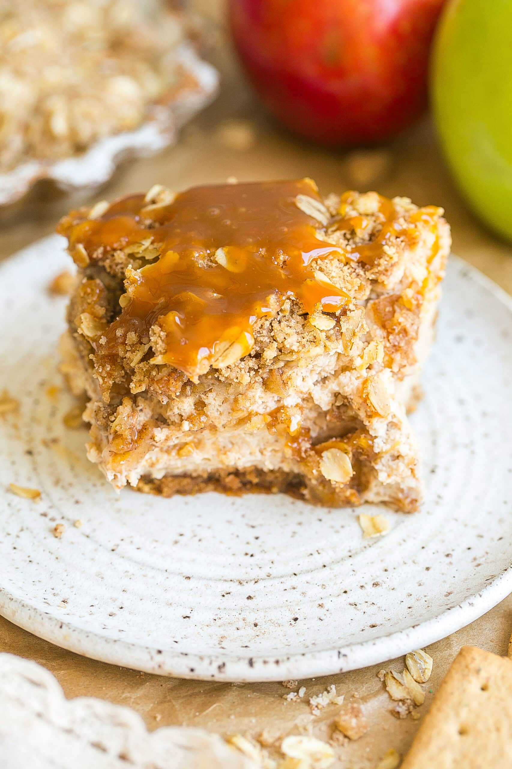 A piece of apple pie cheesecake with a slice cut.