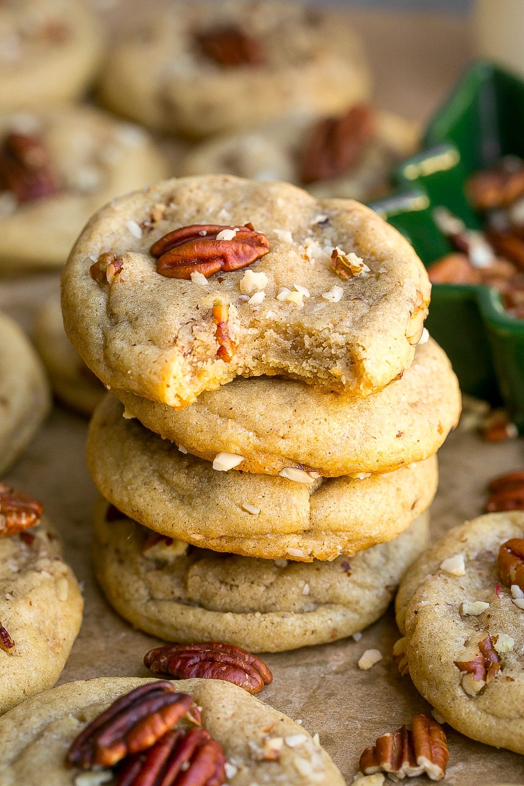 Stack of pecan cookies with bite mark.