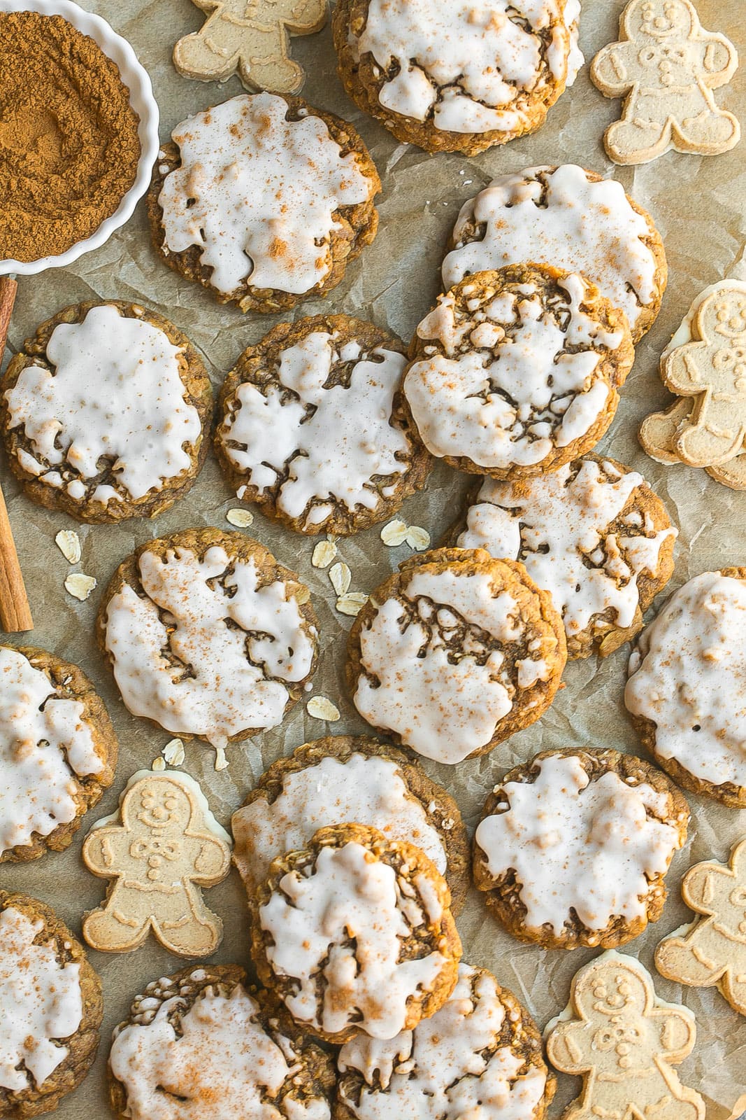 Parchment paper with Iced Gingerbread Oatmeal Cookies. 