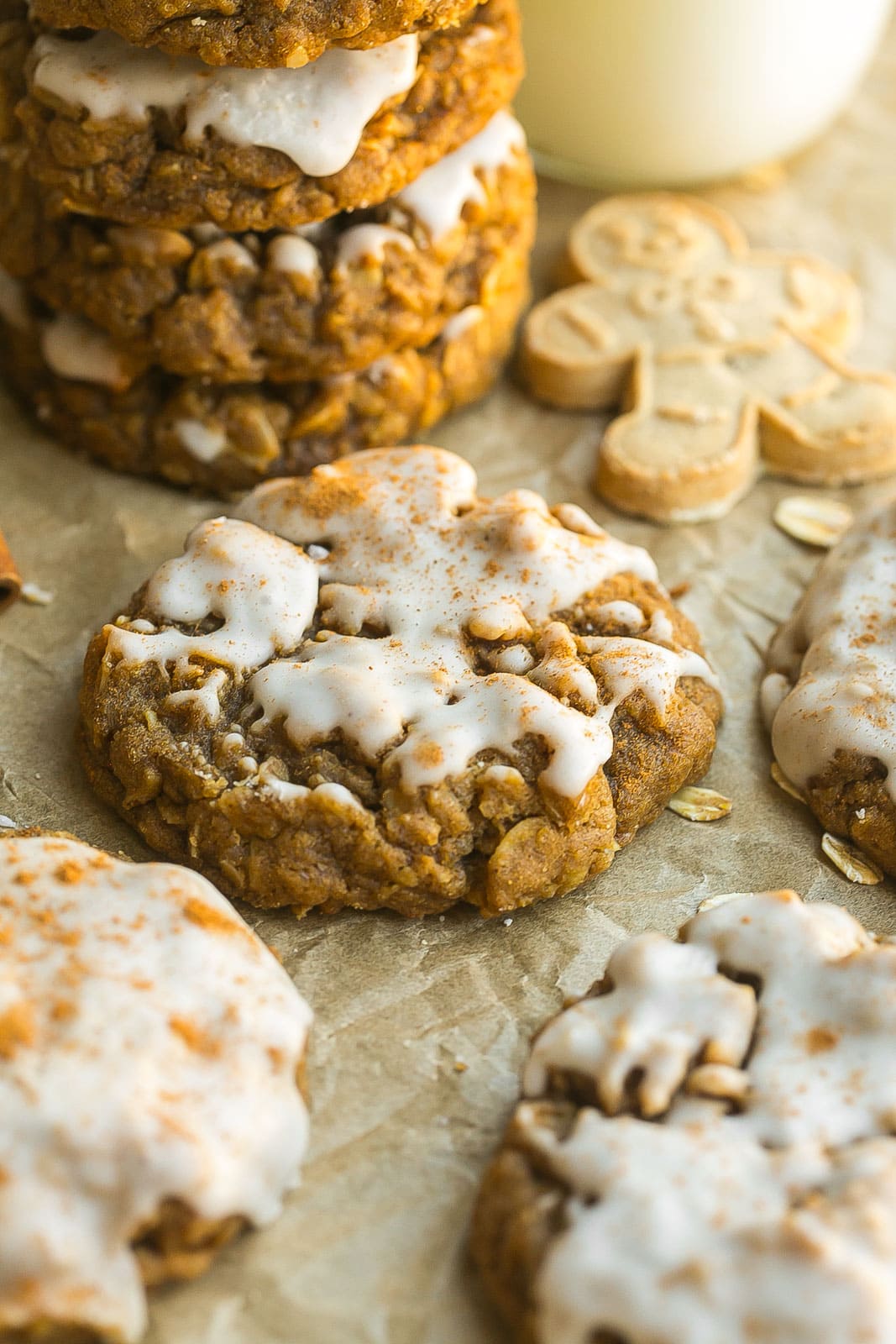 Iced Gingerbread Oatmeal Cookies on parchment paper.