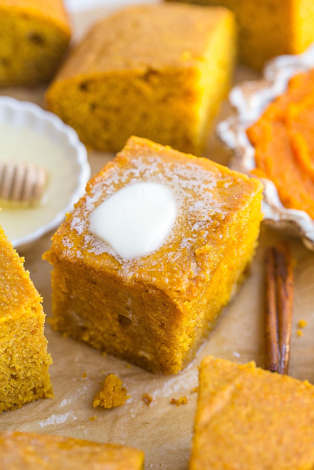 Pumpkin cornbread recipe with pat of melted butter.