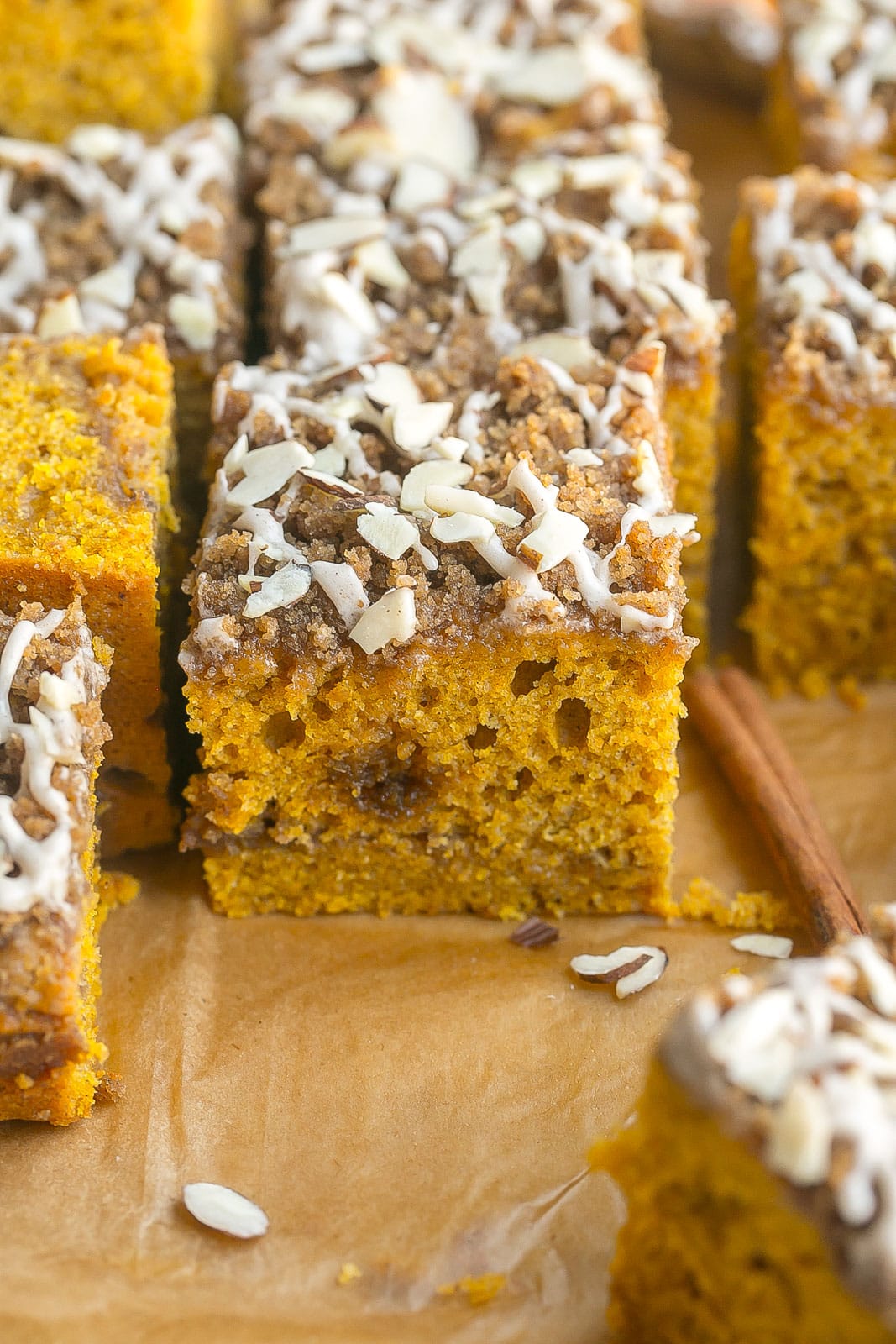 Pumpkin cake with streusel and icing on top.