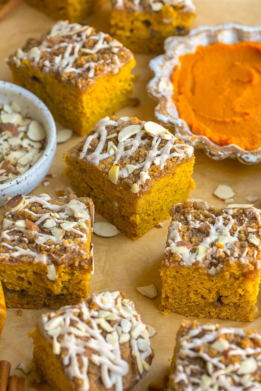 Iced pumpkin coffee cake with nuts on top.