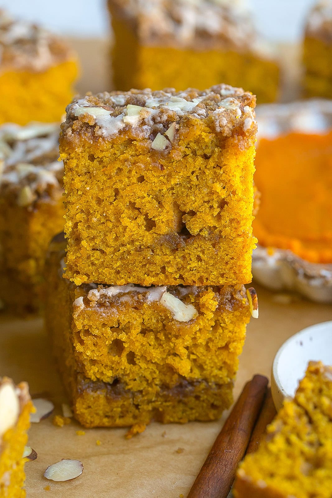 Stack of Pumpkin coffee cake with a cinnamon stick.