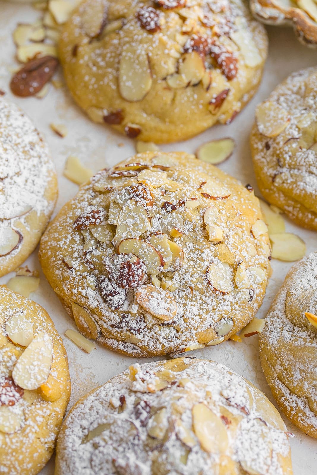 Croissant cookies with almonds and powdered sugar on top.