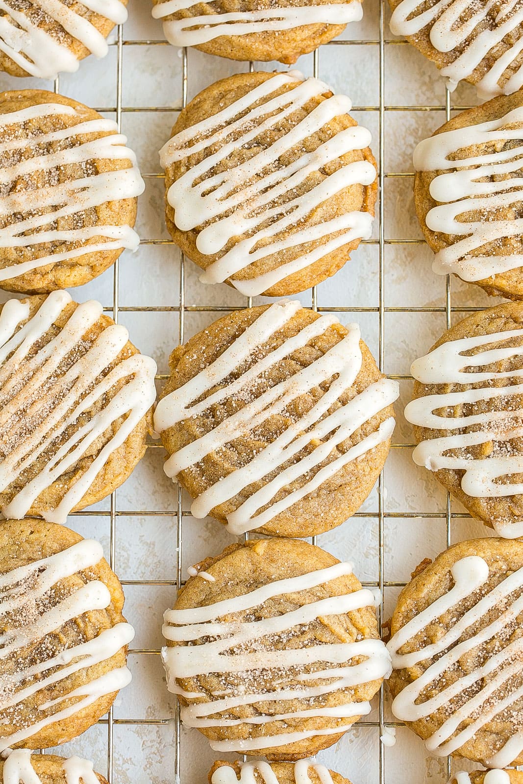 Cinnamon Roll Cookies with Cream Cheese Frosting on cooling rack.