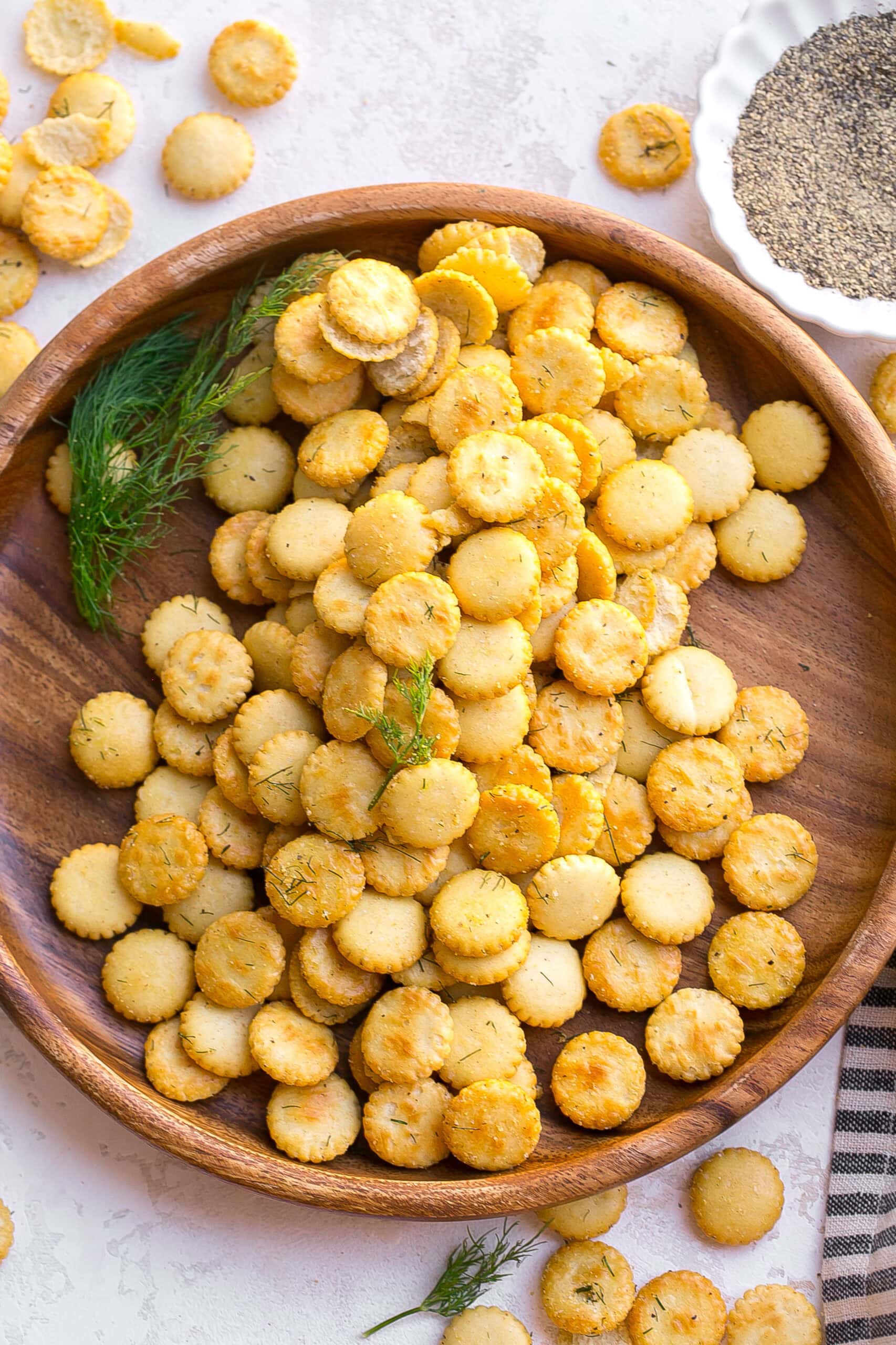 Wooden plate with dill seasoned oyster crackers.