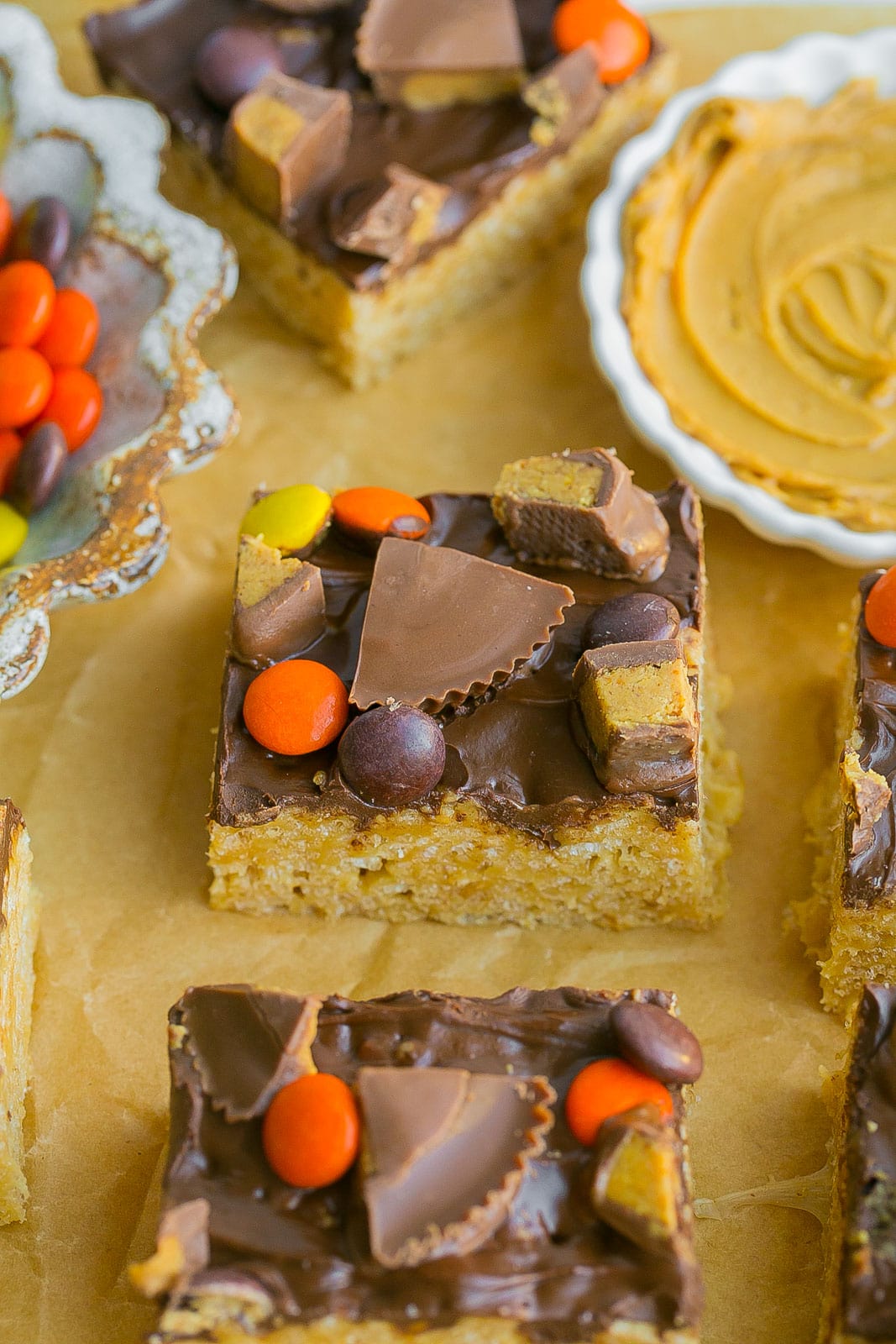 Chocolate Peanut Butter Rice Krispie Treats with candy on top.