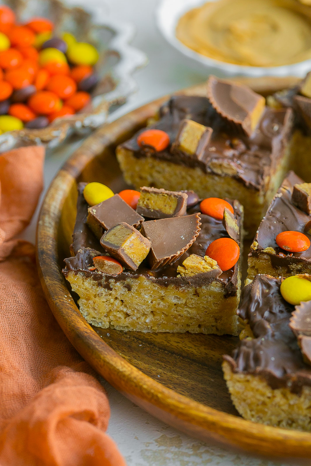 A plate full of rice krispies with peanut butter, chocolate and candies. 