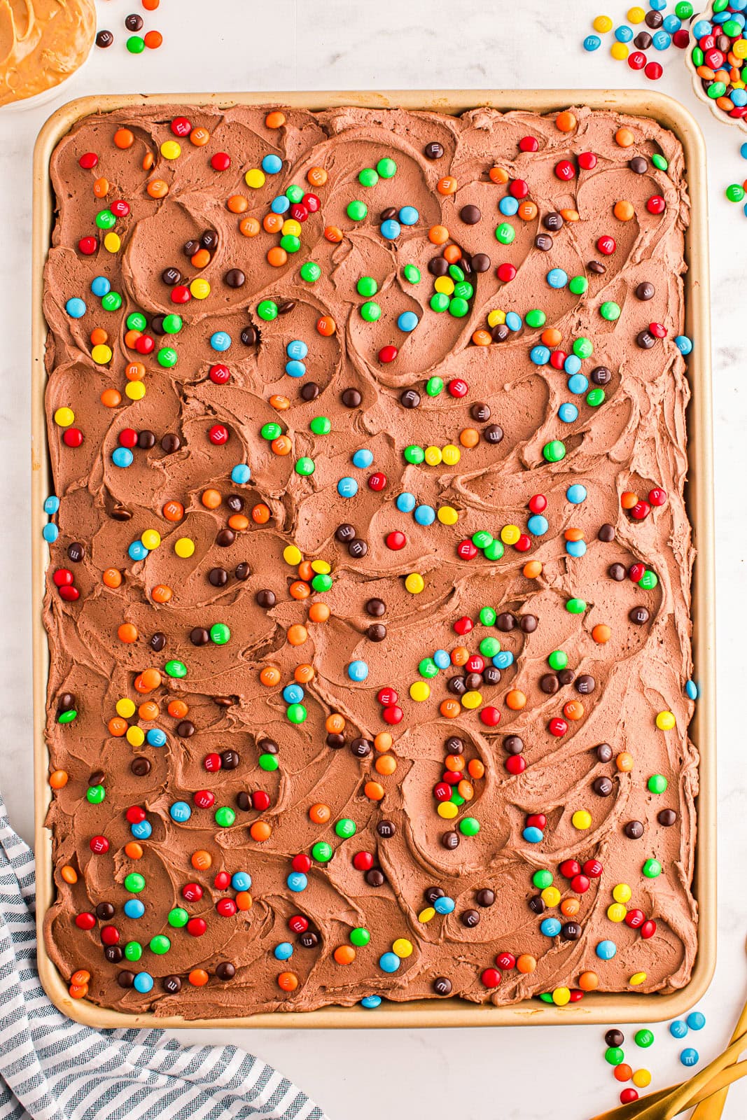 Peanut Butter Sheet Cake with mini M&Ms on top.