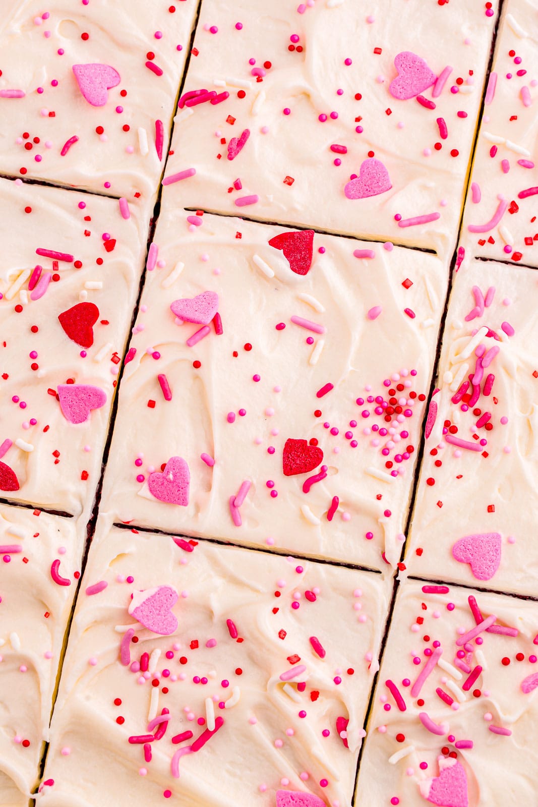 Cake cute into squares with Valentine's day sprinkles.