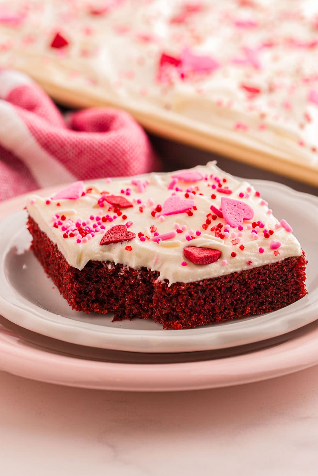 Slice of Valentine's day cake with sprinkles. 