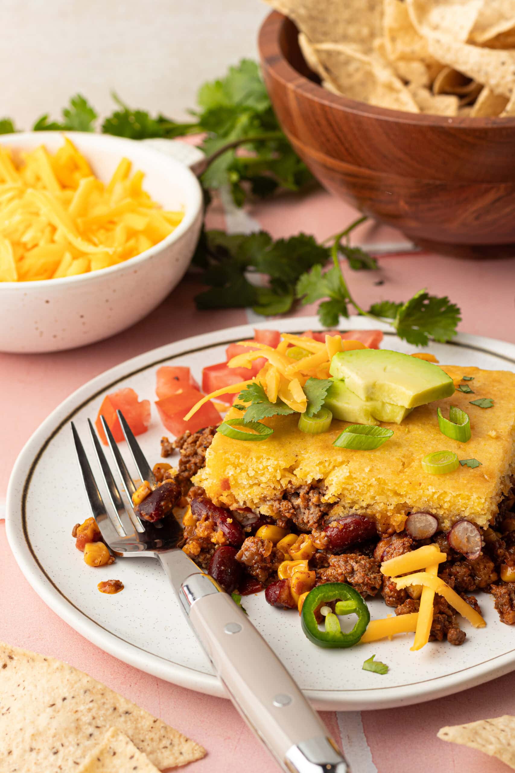 A Taco Casserole with cornbread on a plate. 