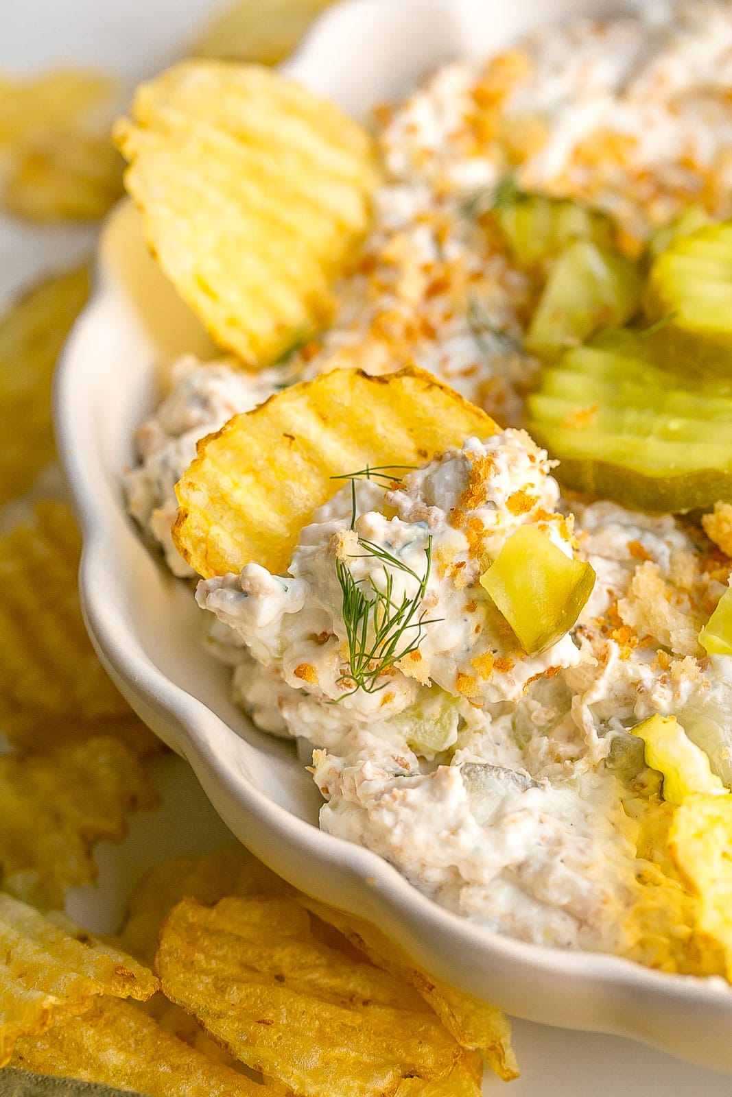 Potato chip with a scoop of pickle dip.