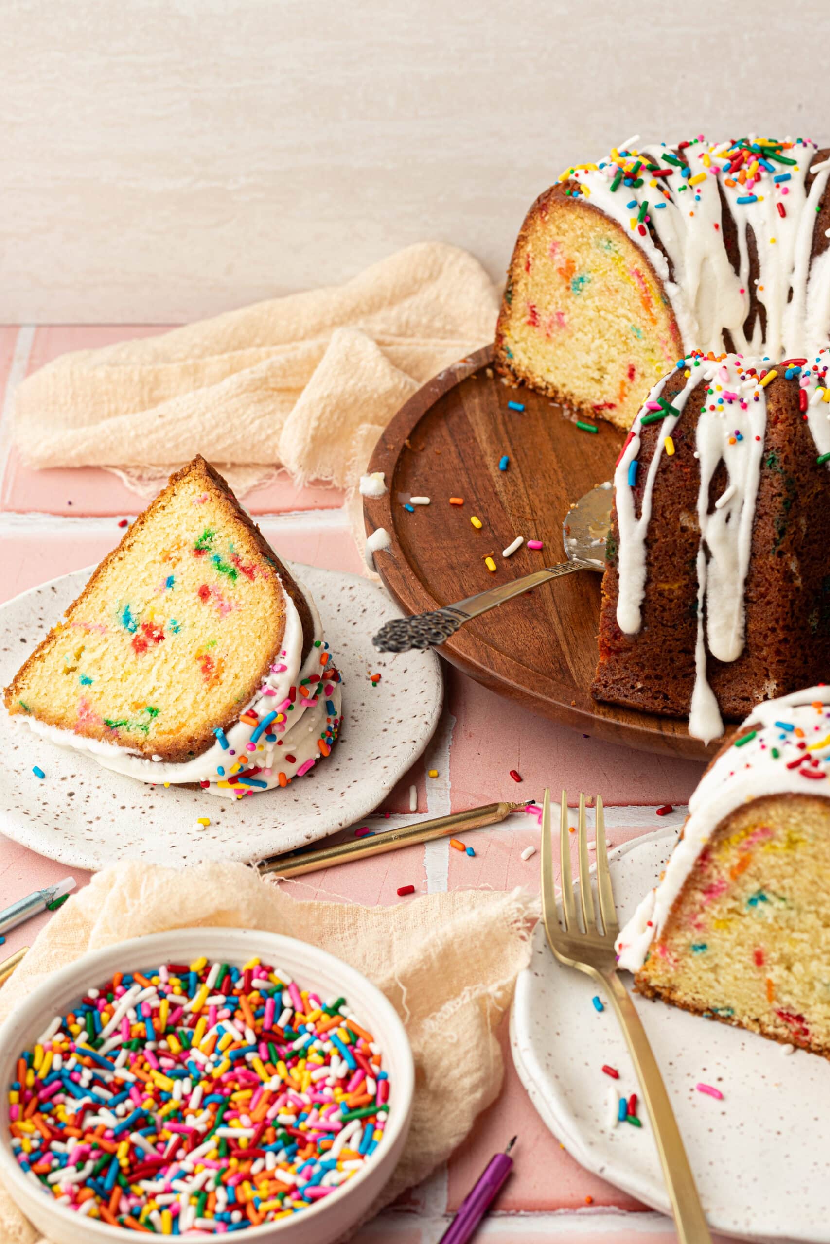 Funfetti cake slices with candles and sprinkles.