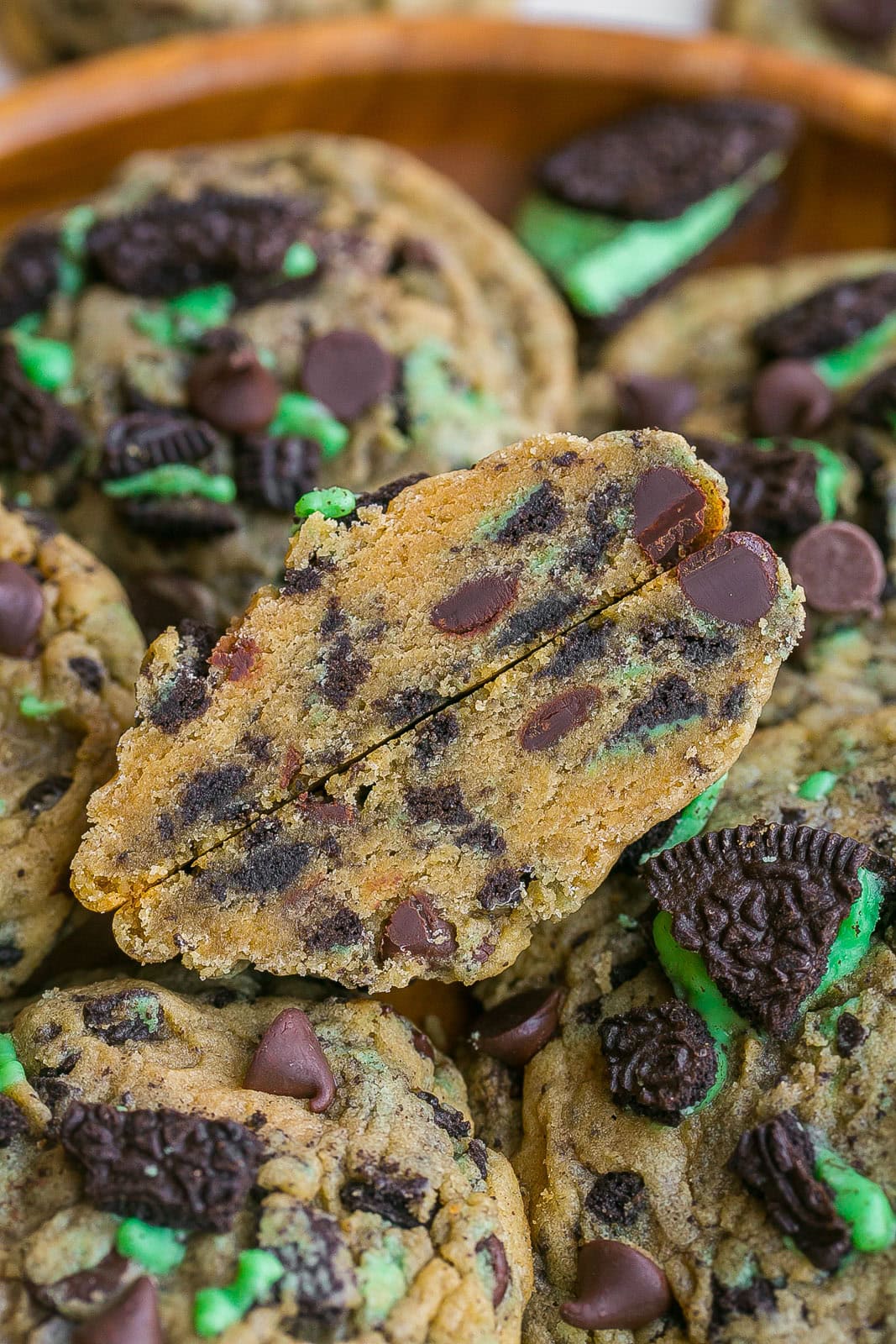 Chocolate chip cookie with mint Oreos cut in half.