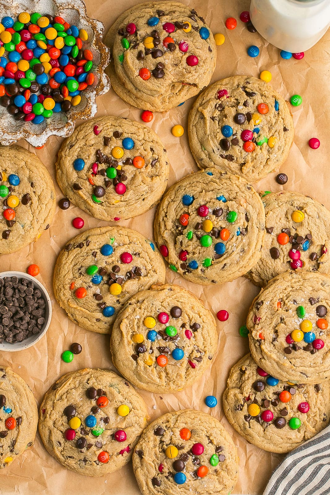 Peanut Butter M&M Cookies on parchment paper with lots of M&Ms.