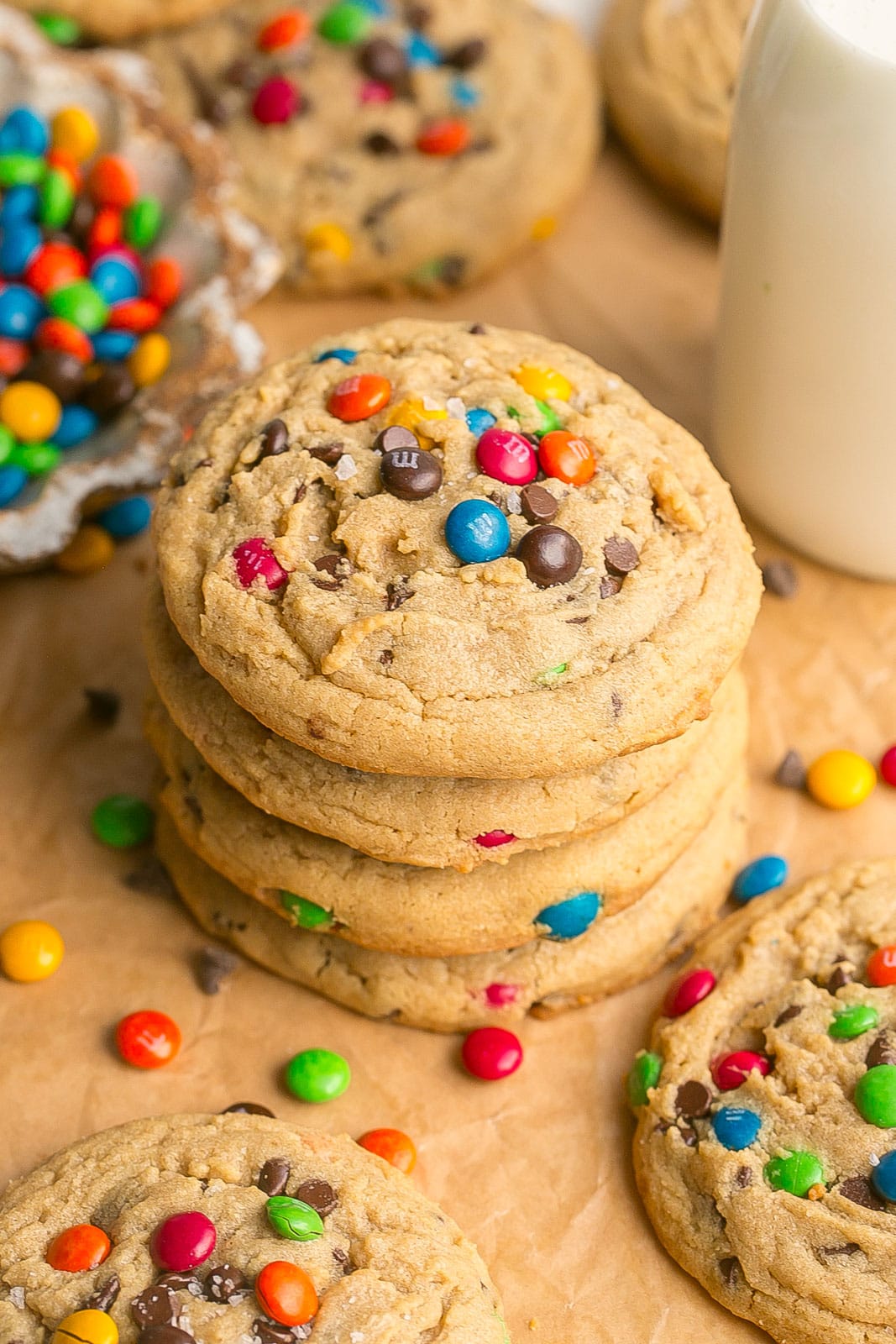 Stack of chewy peanut butter cookies with m&ms and mini chocolate chips.