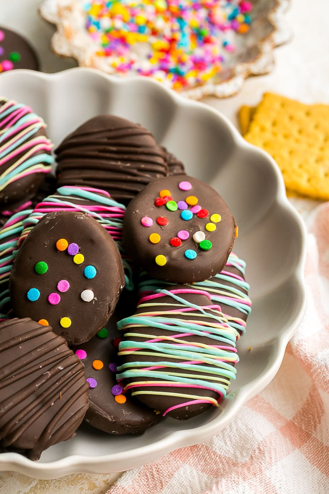 A white bowl full of colorful healthy homemade peanut butter eggs.