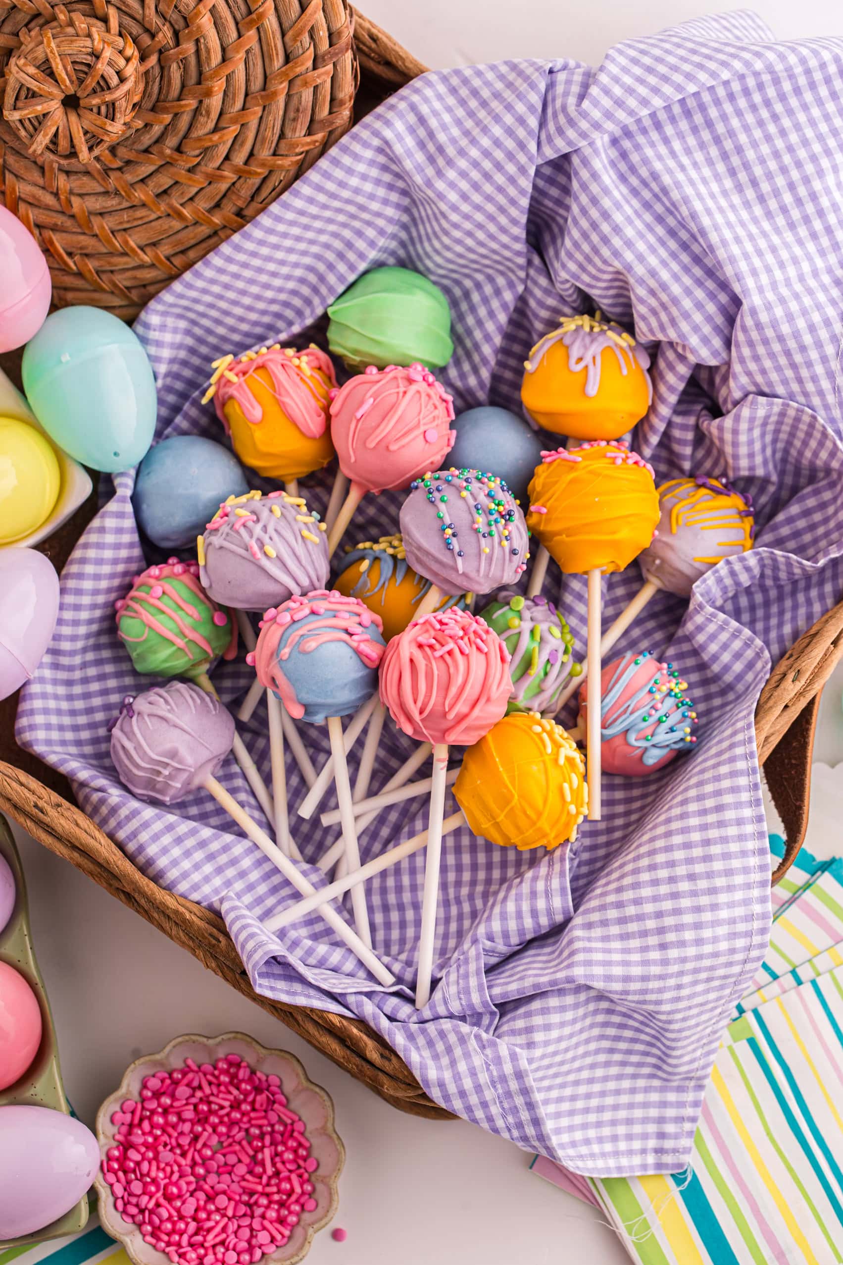 An Easter basket full of colorful Easter Cake Pops.