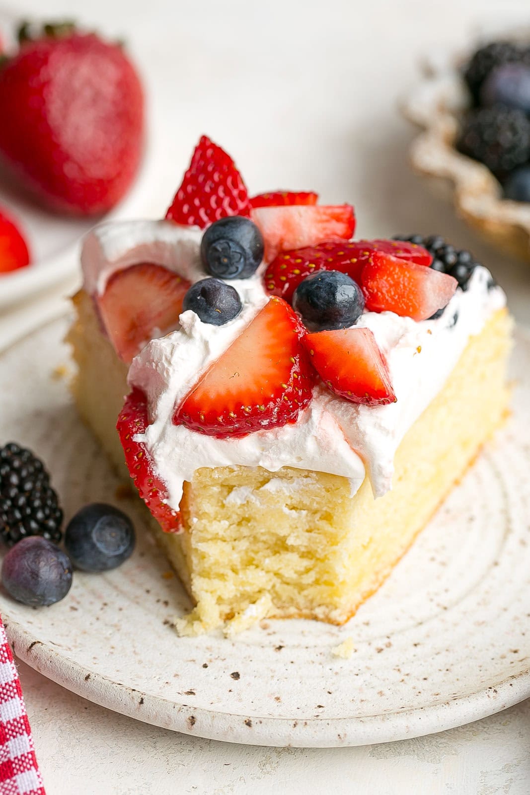 Slice of Berries and Cream Cake with fork mark.