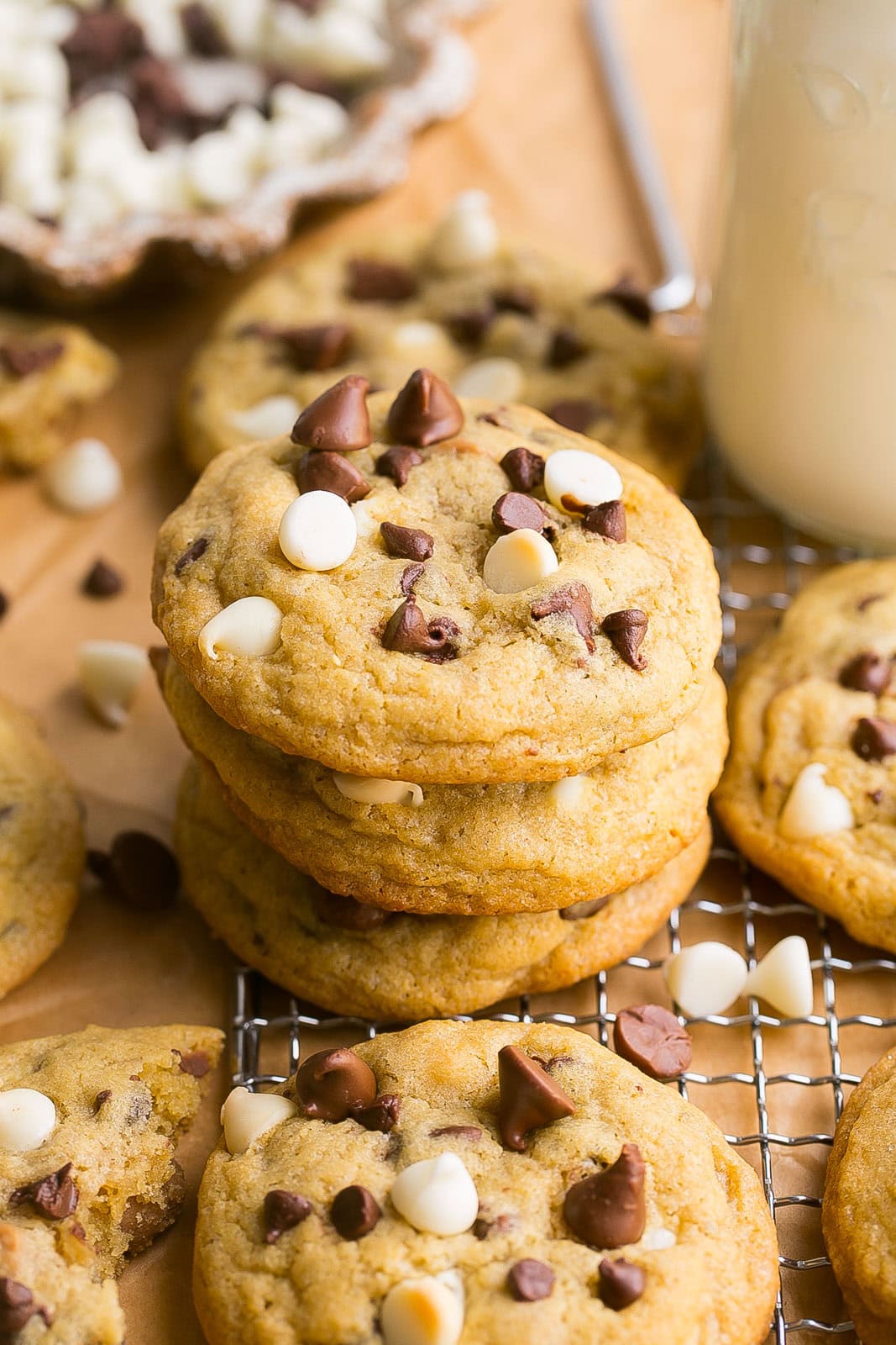 Triple Chocolate Chip Cookies stacked on a cooling rack.