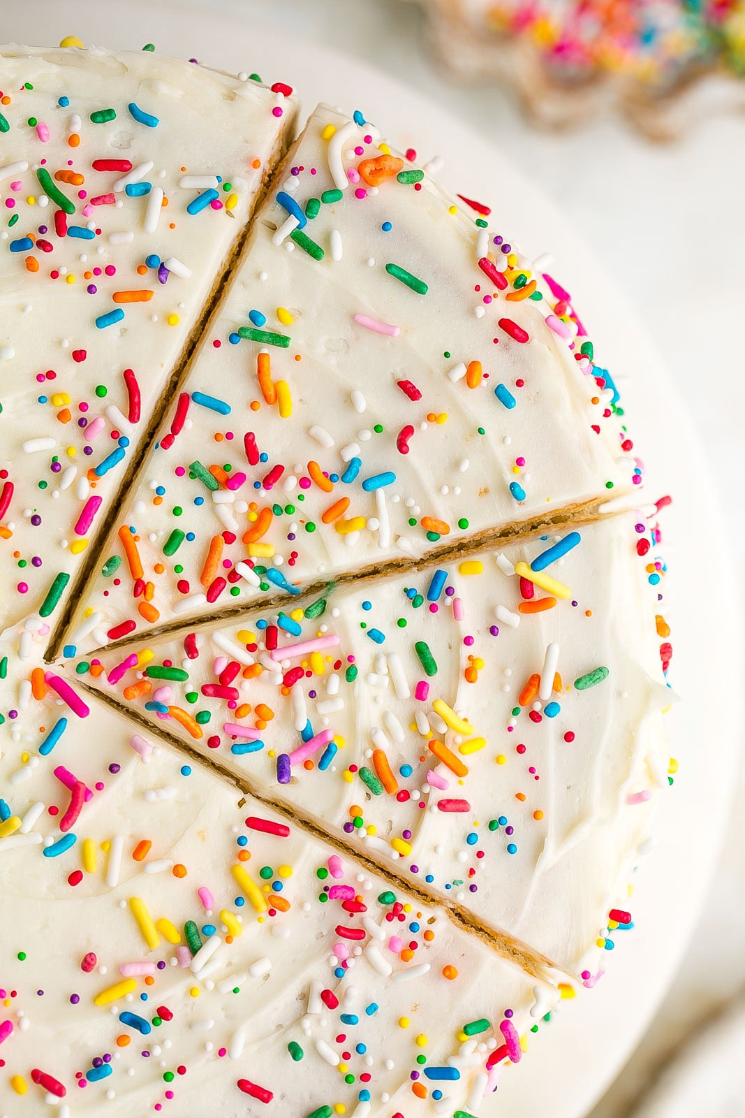 Buttermilk Cake with slices marks and sprinkles.