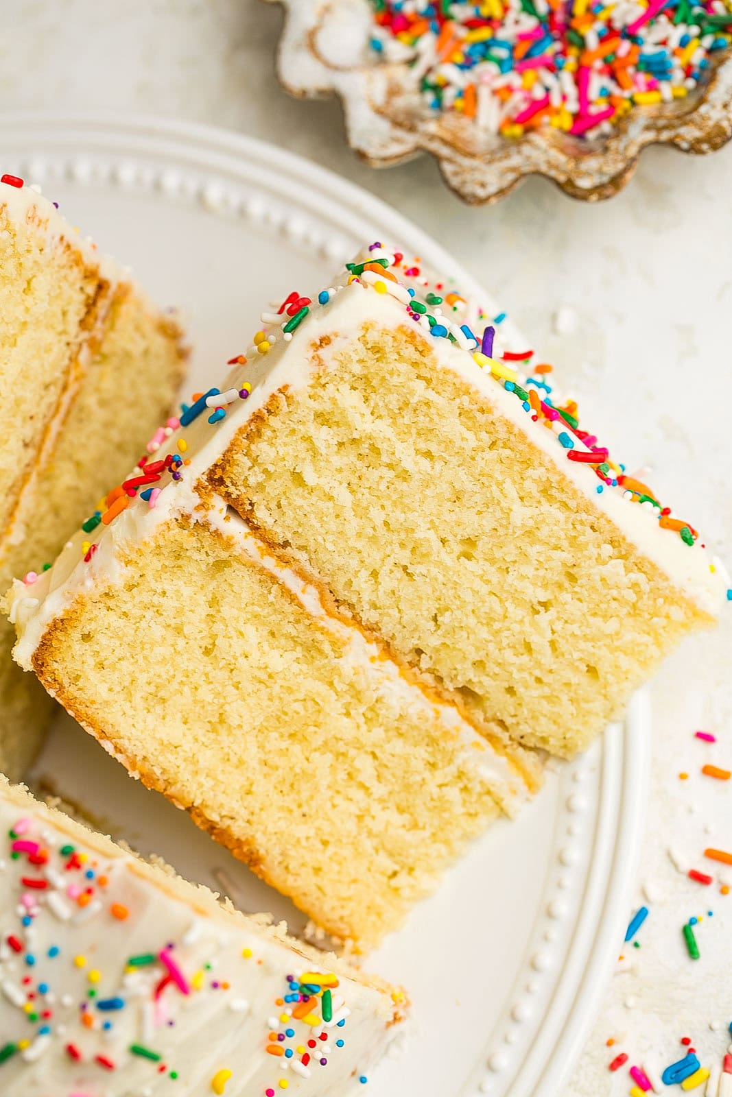 Side view of a slice of vanilla cake.