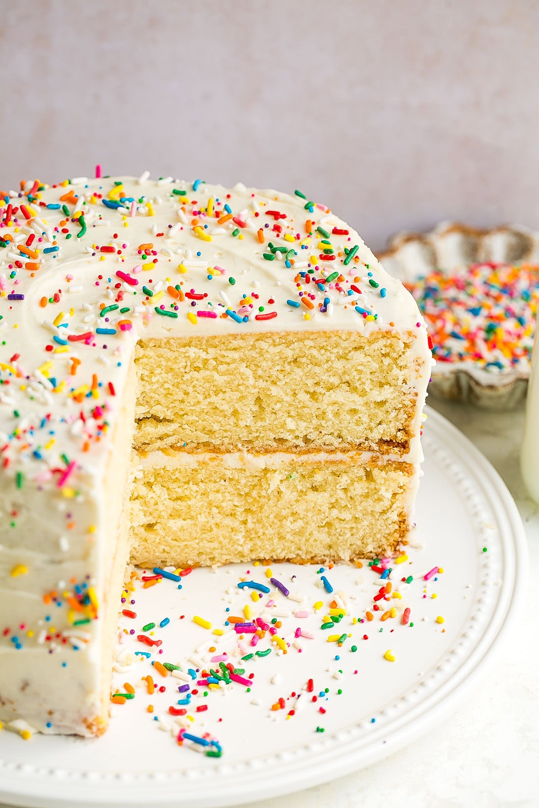 Side view of buttermilk cake with piece removed. 