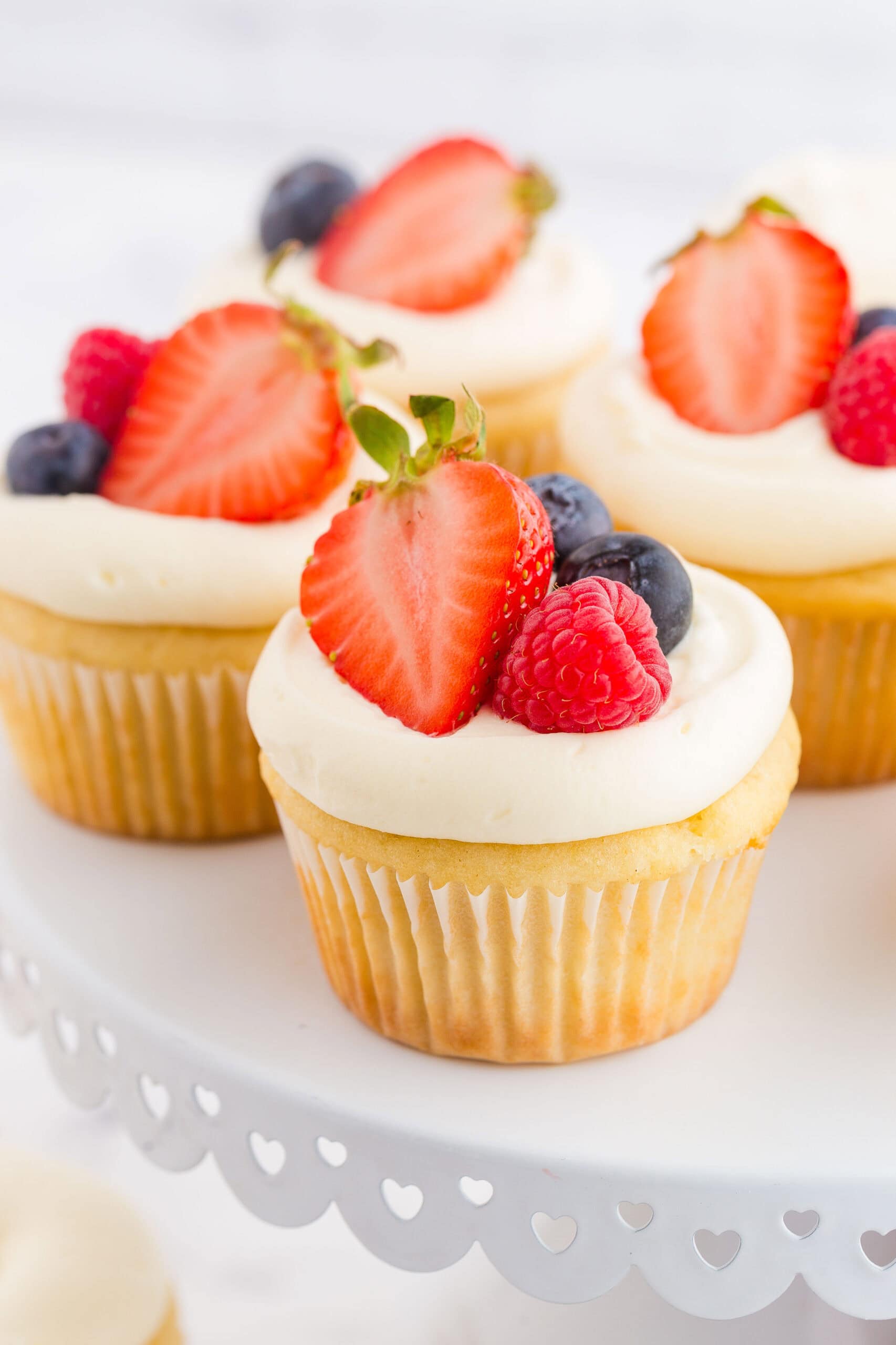 Cupcakes with berries on top.