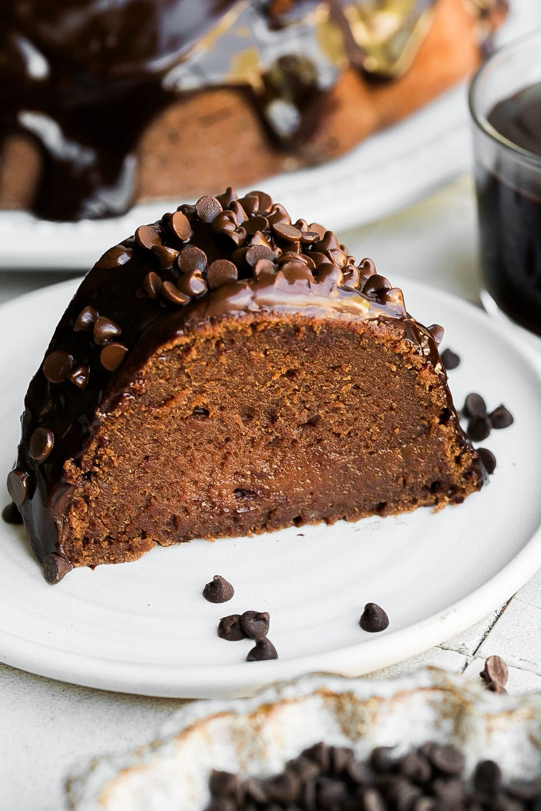 Slice of Double Chocolate Cake with chocolate ganache on top.
