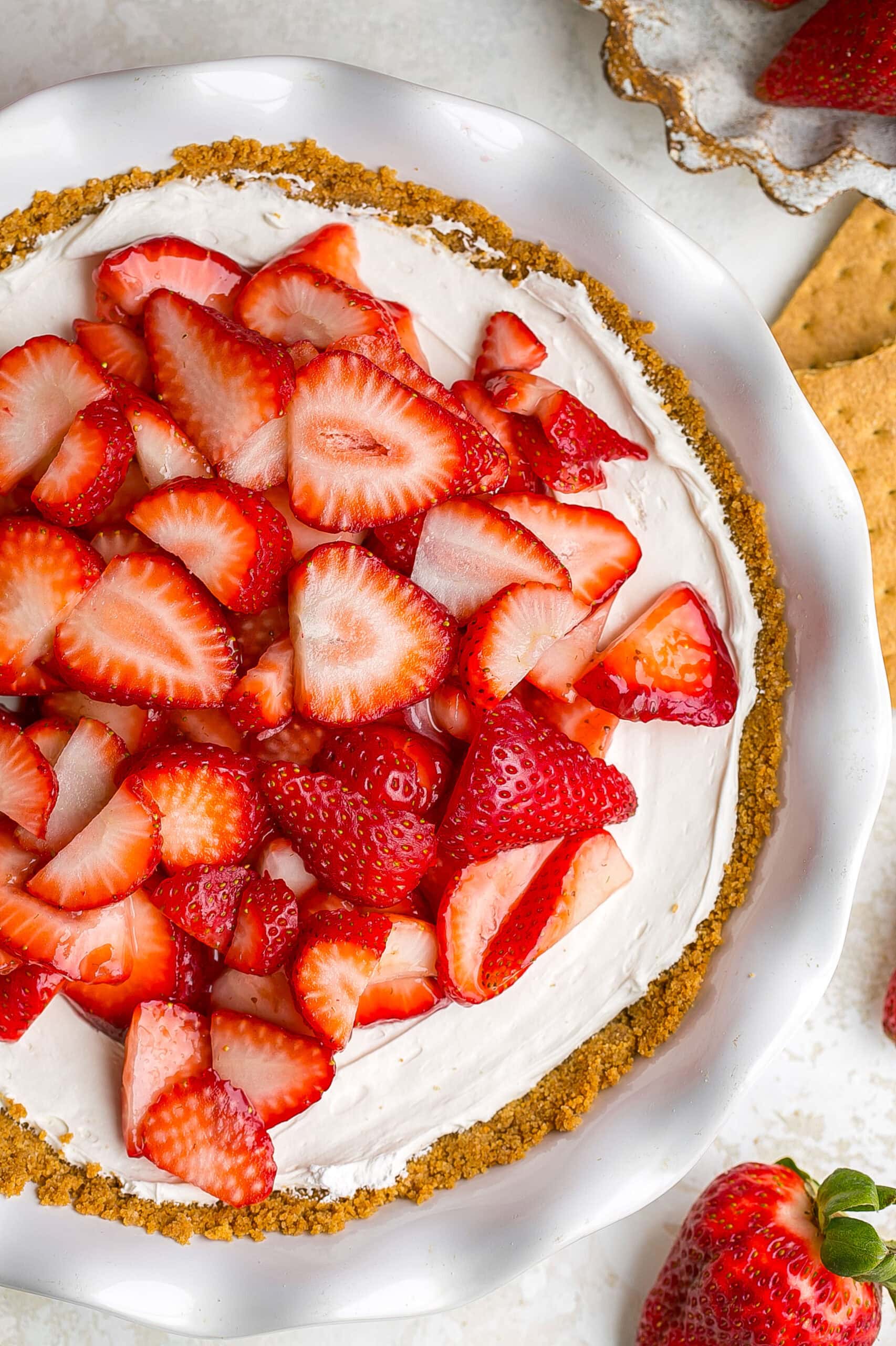 Close up view of fresh strawberries on cream cheese pie.