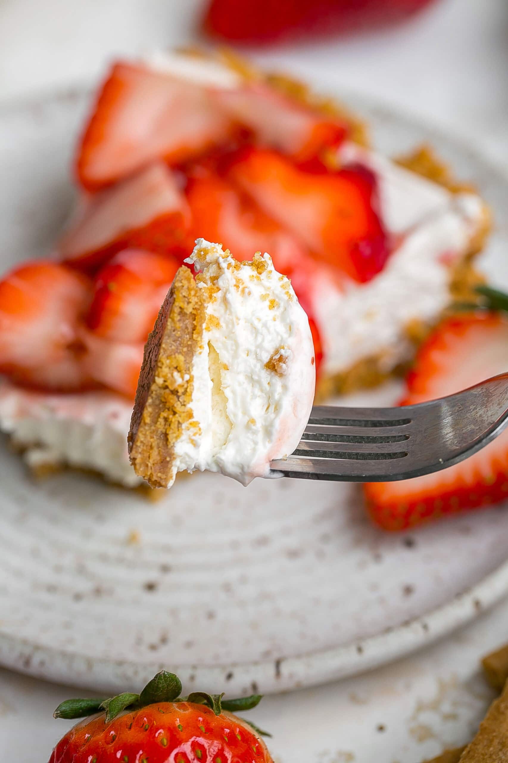 Bite of pie with graham cracker crust.
