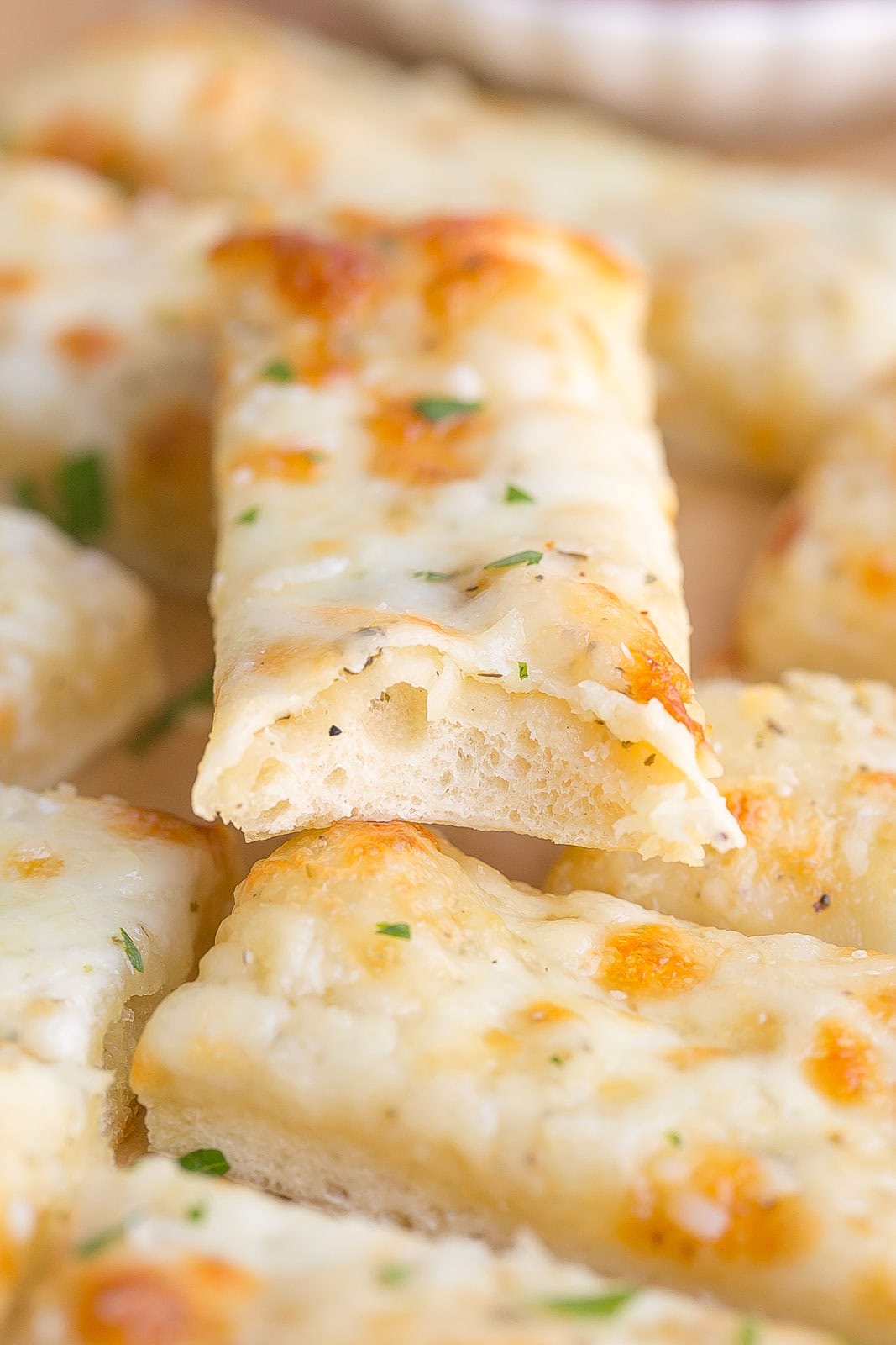 Bite of a cheesy breadstick.