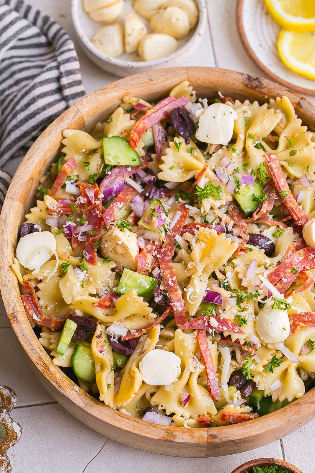 Bow Tie Pasta Salad with salami and mozzarella on top.
