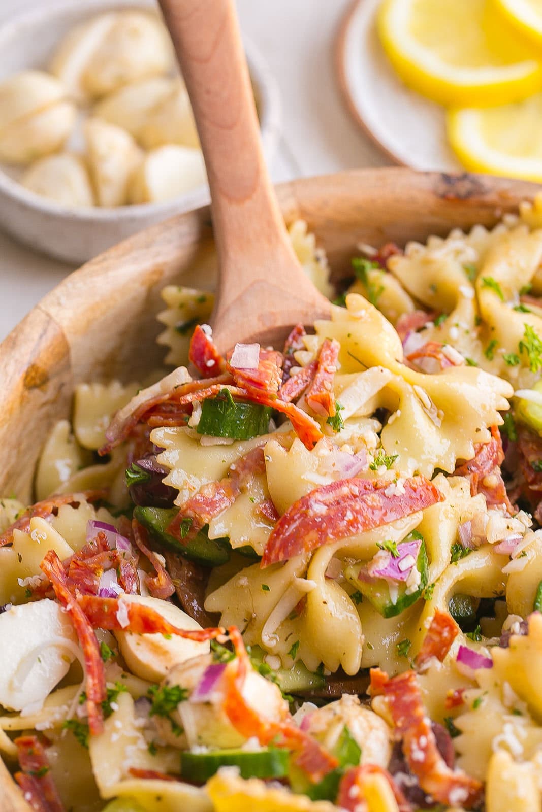 Spoonful of bow tie pasta salad.