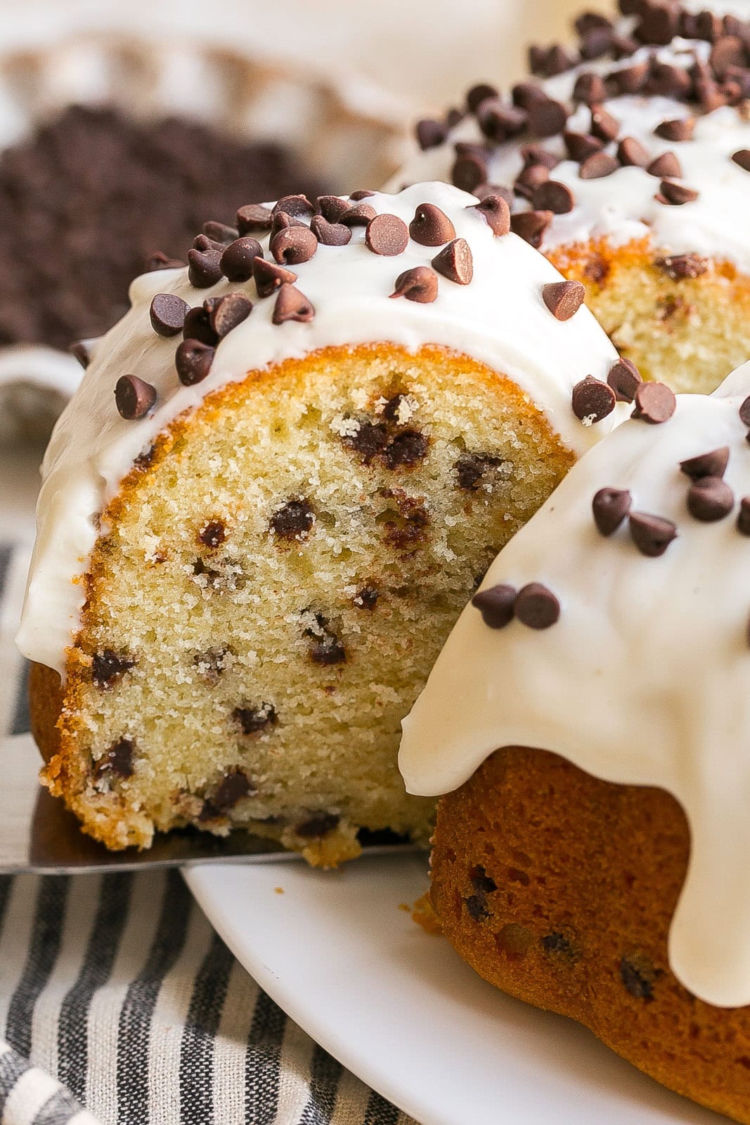 Slicing of bundt cake with chocolate chips.