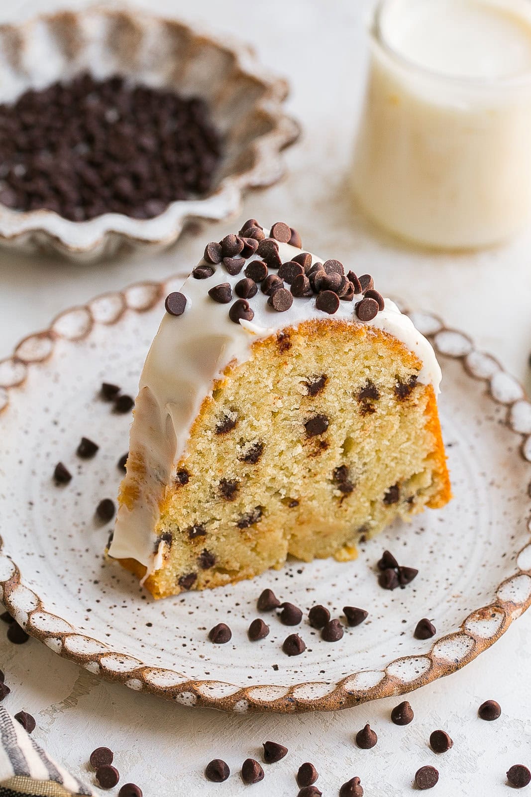 Slice of Chocolate Chip Bundt Cake With Vanilla Frosting.